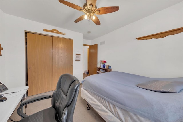 carpeted bedroom with ceiling fan, visible vents, and a closet