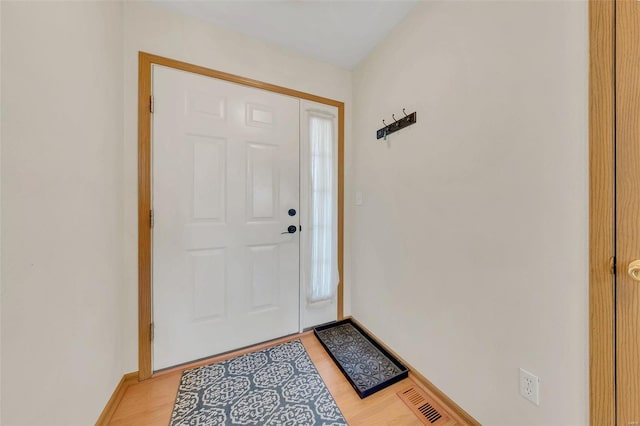 entrance foyer featuring light wood-style floors, visible vents, and baseboards