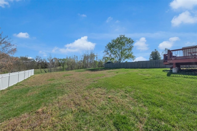 view of yard featuring a wooden deck and fence