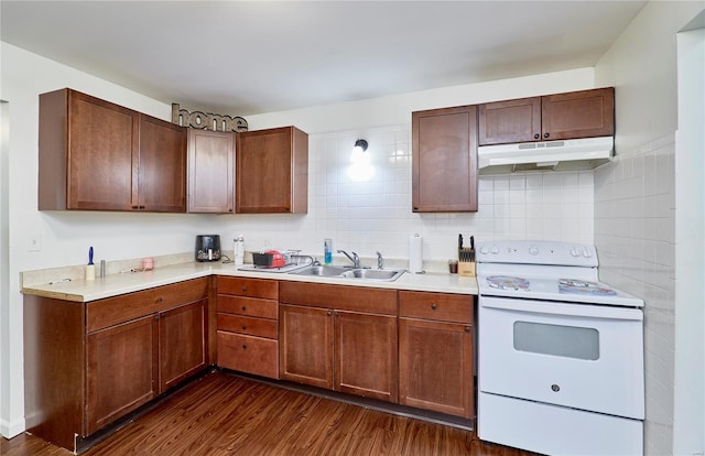 kitchen featuring under cabinet range hood, a sink, dark wood-style floors, and white range with electric cooktop