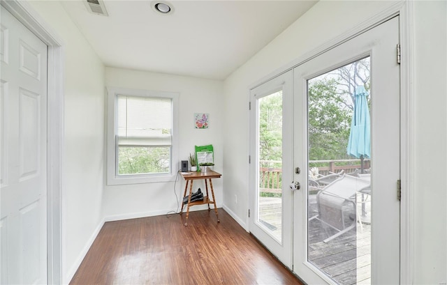 doorway to outside featuring french doors, wood finished floors, baseboards, and visible vents