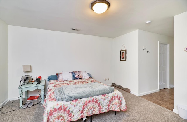 carpeted bedroom featuring visible vents and baseboards