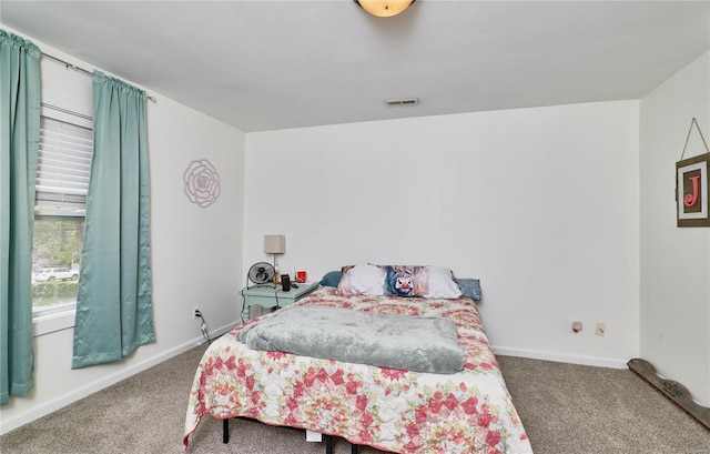 bedroom featuring visible vents, baseboards, and carpet floors