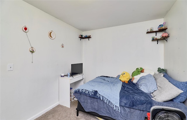 carpeted bedroom featuring baseboards