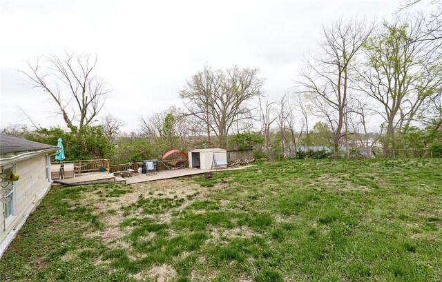 view of yard with an outdoor structure and a wooden deck