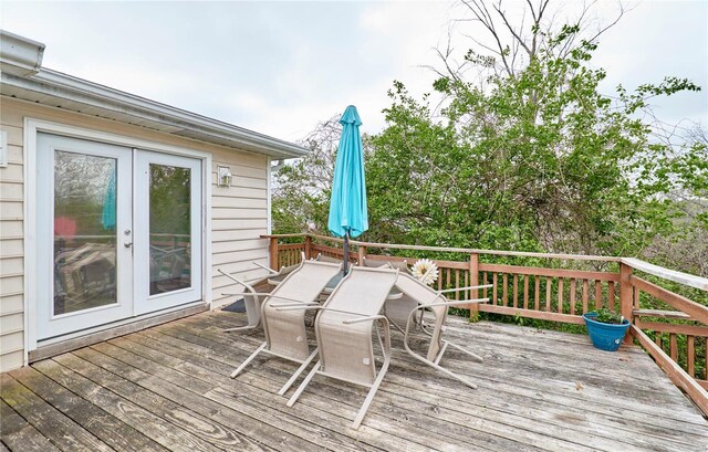 wooden deck featuring outdoor dining area