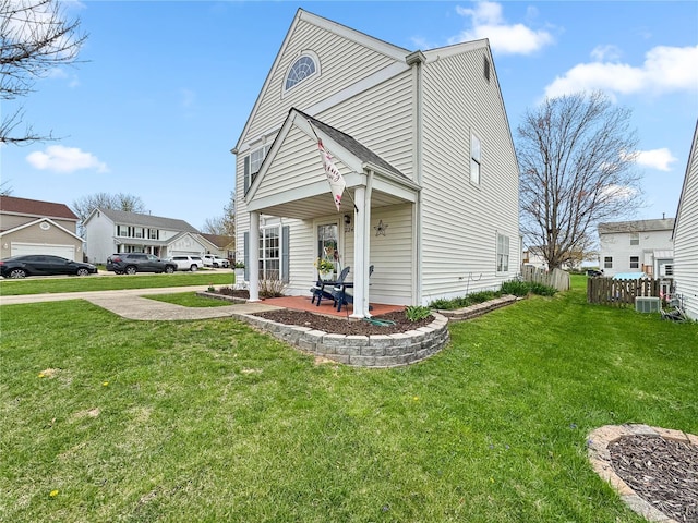view of front of house with fence and a front lawn