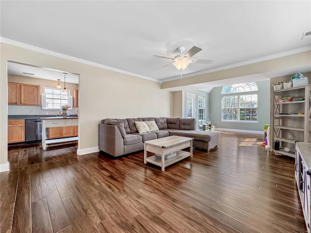 living area with a healthy amount of sunlight, baseboards, ceiling fan, and dark wood finished floors