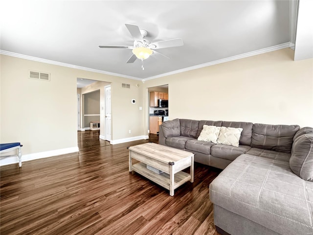 living room with visible vents, dark wood-style flooring, crown molding, and a ceiling fan