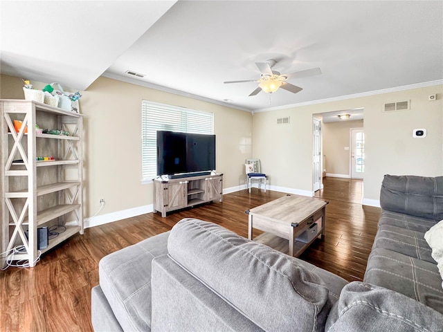 living room featuring wood finished floors, ornamental molding, and visible vents