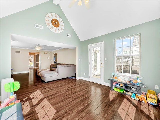 living area featuring visible vents, a ceiling fan, and wood finished floors