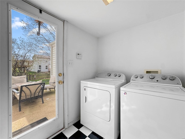 laundry room with tile patterned floors, washer and dryer, and laundry area