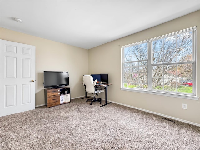 office space with visible vents, baseboards, and carpet