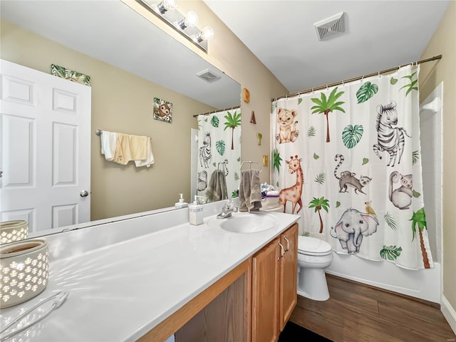 full bath featuring vanity, visible vents, toilet, and wood finished floors