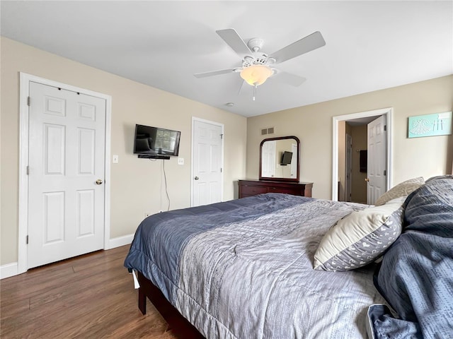 bedroom featuring visible vents, baseboards, a ceiling fan, and wood finished floors