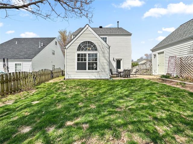 back of house featuring a patio area, a fenced backyard, and a lawn