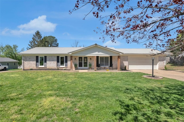 single story home with brick siding, an attached garage, metal roof, and concrete driveway