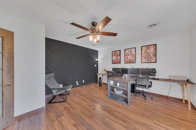 office featuring visible vents, baseboards, and wood finished floors