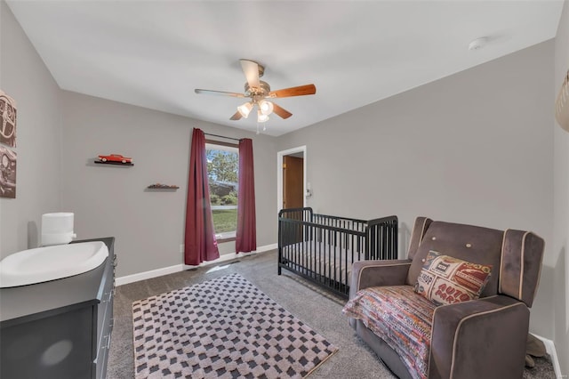 carpeted bedroom with baseboards and a ceiling fan