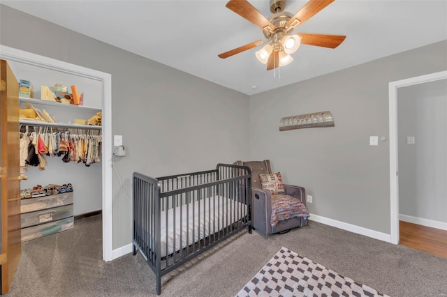 carpeted bedroom with ceiling fan and baseboards