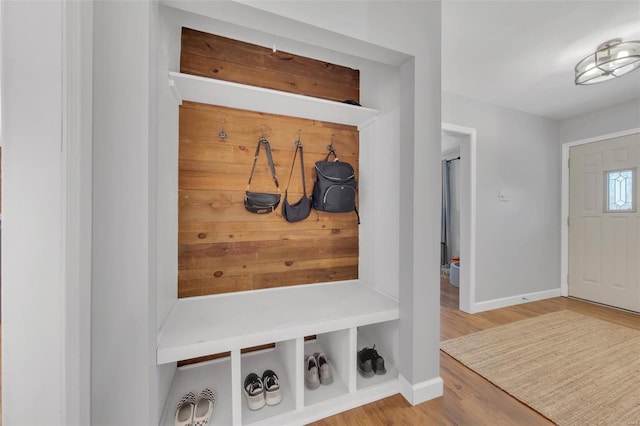 mudroom featuring wood finished floors and baseboards