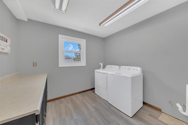 washroom featuring independent washer and dryer, light wood finished floors, laundry area, and baseboards