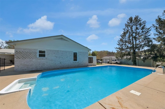 view of swimming pool featuring a fenced in pool, a patio, and fence