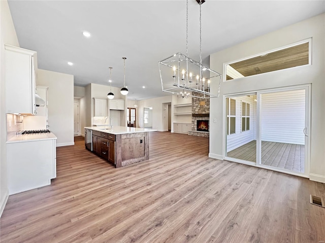 kitchen featuring open floor plan, light wood-type flooring, a sink, and stainless steel appliances