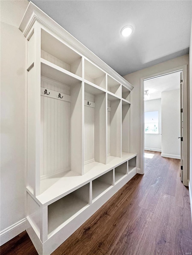 mudroom featuring baseboards and dark wood finished floors