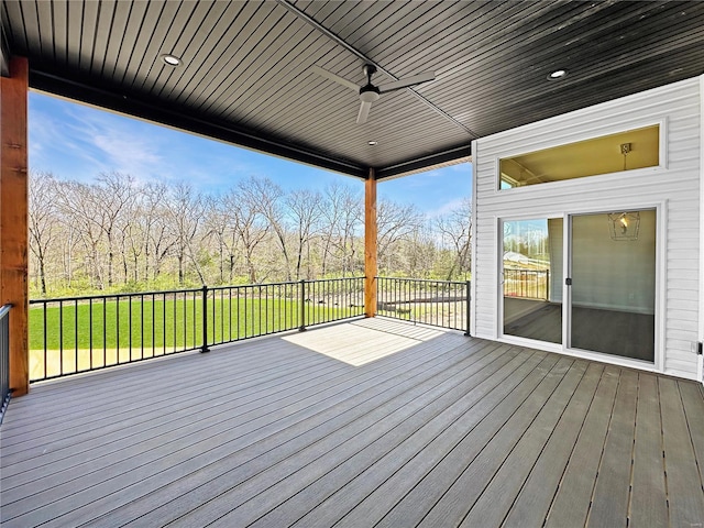 deck featuring a yard and ceiling fan