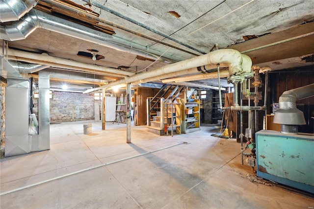 unfinished basement with heating unit, freestanding refrigerator, and stairs