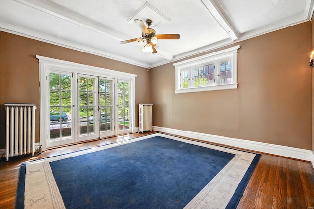 unfurnished room featuring a ceiling fan, baseboards, radiator heating unit, and wood finished floors