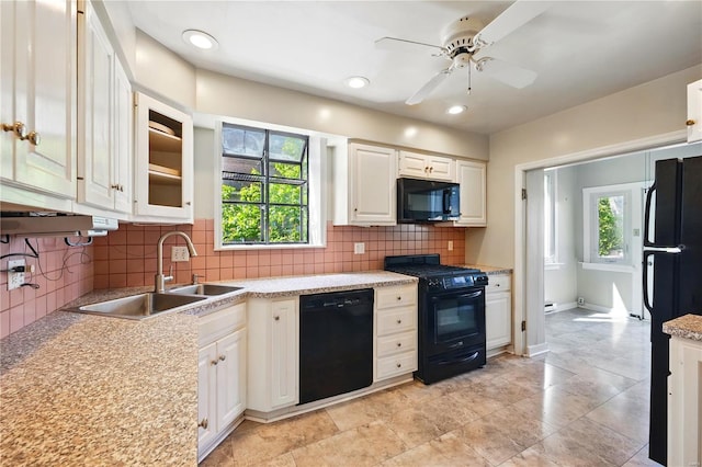 kitchen with a sink, backsplash, a ceiling fan, light countertops, and black appliances