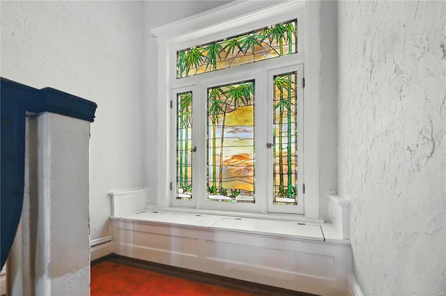 doorway with a textured wall and a wealth of natural light