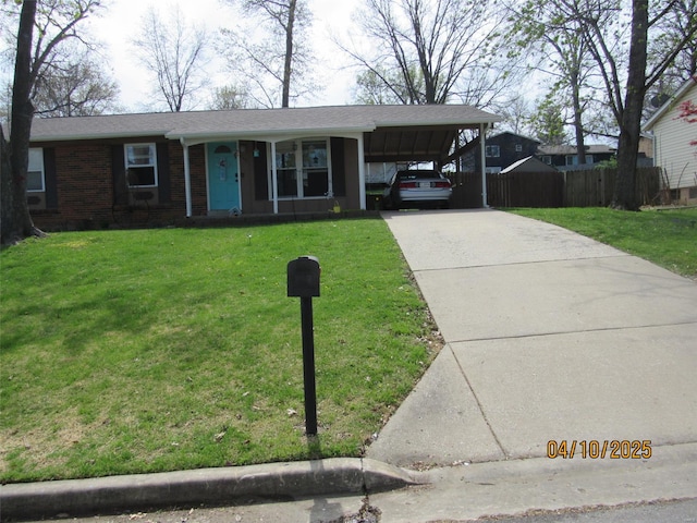 ranch-style house with fence, a front lawn, brick siding, concrete driveway, and an attached carport