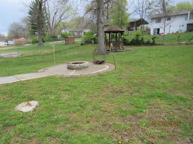 view of yard featuring a gazebo, fence, and an outdoor fire pit
