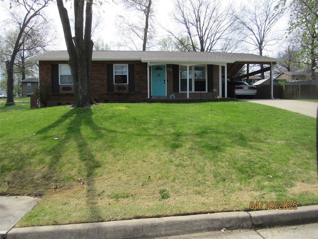 ranch-style home with a front yard, brick siding, a carport, and driveway