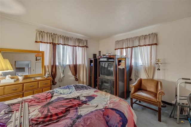 bedroom with ornamental molding and carpet