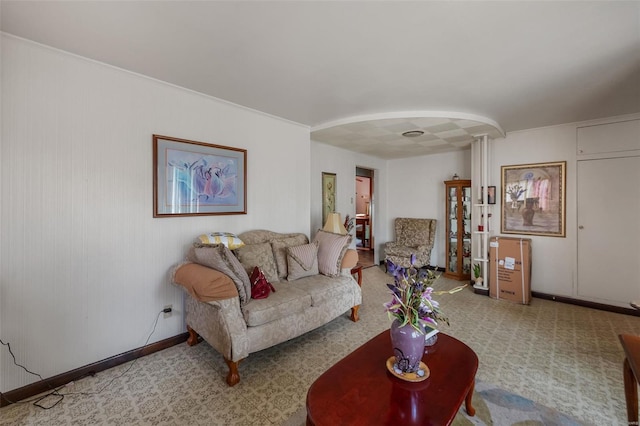 living room with arched walkways and baseboards
