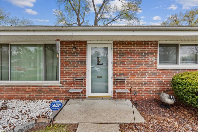 property entrance featuring brick siding
