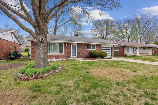 ranch-style home with brick siding, driveway, and a front yard