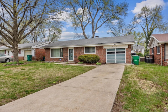 ranch-style home featuring central AC, an attached garage, driveway, brick siding, and a front yard