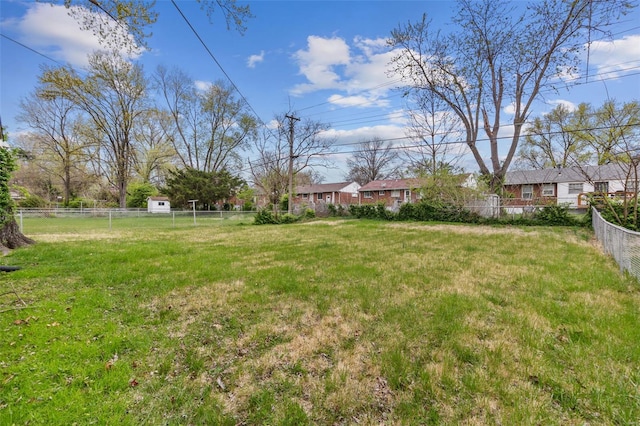 view of yard with a residential view and fence