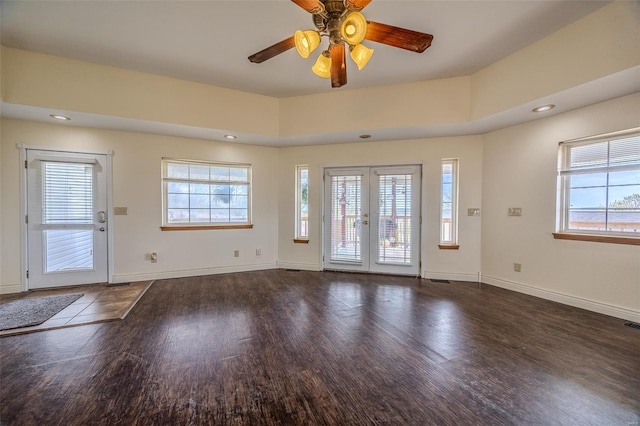 interior space featuring a ceiling fan, a healthy amount of sunlight, and wood finished floors