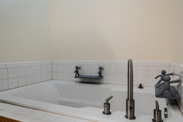 full bath with a garden tub and a sink