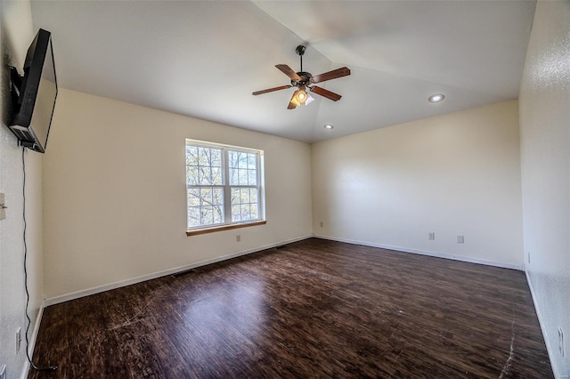 spare room featuring recessed lighting, lofted ceiling, a ceiling fan, baseboards, and dark wood-style flooring