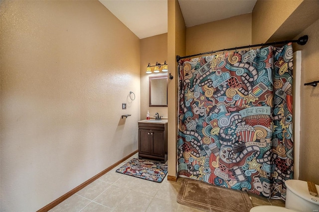 full bath featuring curtained shower, tile patterned flooring, toilet, vanity, and baseboards