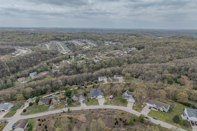 birds eye view of property featuring a view of trees and a residential view
