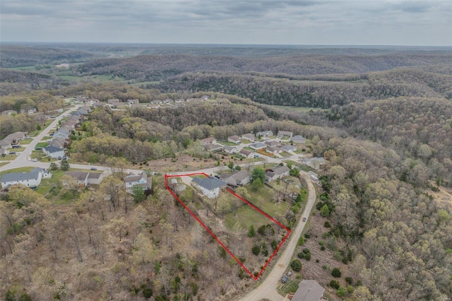 bird's eye view featuring a residential view and a wooded view