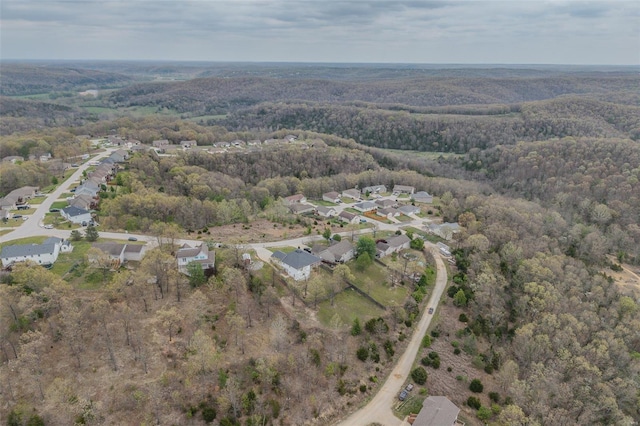 aerial view featuring a forest view and a residential view